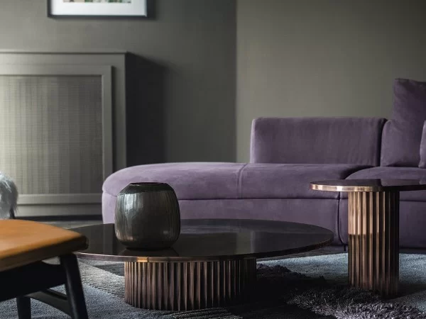 The Allure side tables in polished antique copper